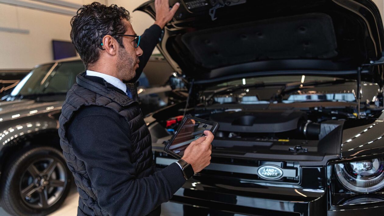 Inspecting vehicle engine bay        